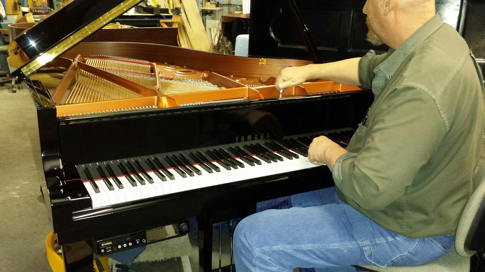 Gist piano tuning being done by a Gist employee