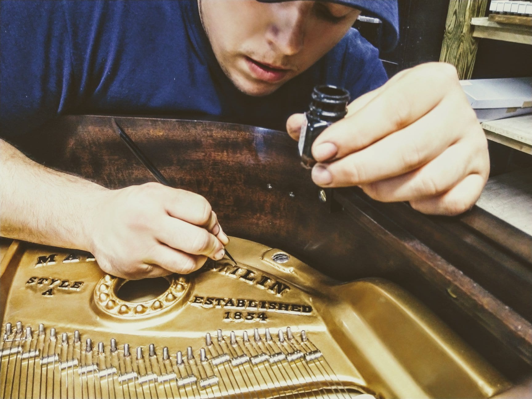 Employee completing Piano restoration at Gist